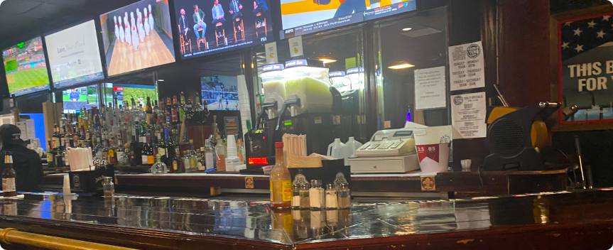 Bar with multiple screens and drinks